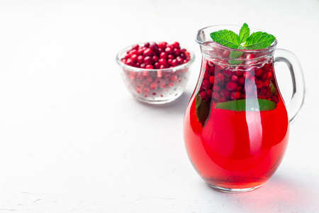 Lingonberry and lime punch or limeade in a glass jar, horizontal, copy space