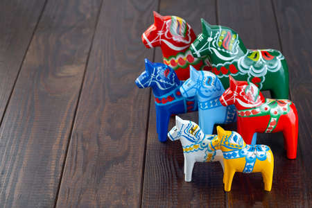 Swedish traditional souvenir wooden dala horses, hand craft made and painted, different colors and...
