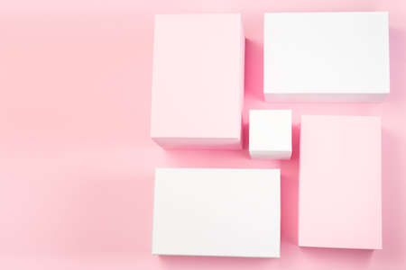 Pink and white geometrical podiums on a pink background, horizontal, copy space, top view