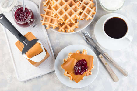 Homemade waffles with norwegian brown cheese and lingon jam, horizontal,  top view