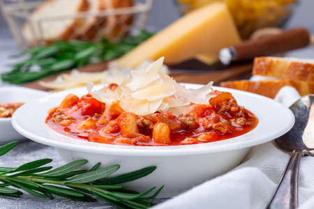 Minestrone soup with cavatappi pasta, beans and vegetables, served with crispy bread, horizontalの写真素材