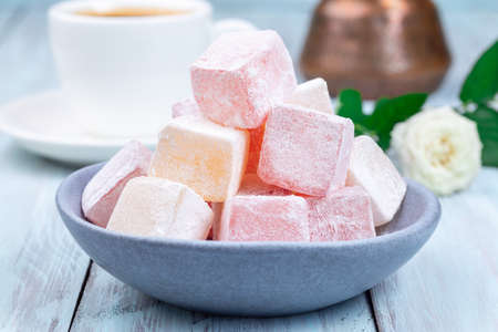 Turkish delight or lokum confection rose and lemon flavored with cup of coffee and cezve, closeupの写真素材