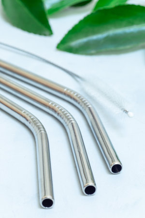 Reusable stainless steel straws and cleaning brush, eco friendly zero waste concept, verticalの写真素材