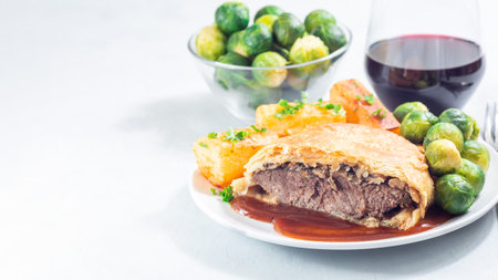Beef Wellington, served with brussels sprouts and Chateau potato, copy spaceの写真素材