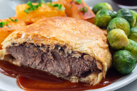 Homemade Beef Wellington with mushroom Duxelles, served with brussels sprouts and Chateau potatoの写真素材