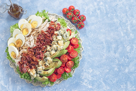 Delicious Cobb salad on a white plate, horizontal top view copy spaceの写真素材