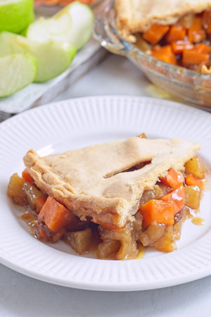 Delicious homemade apple and sweet potato cobbler pie showing filling ingredients, verticalの写真素材