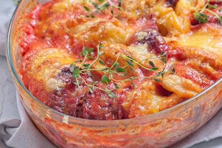 Sweet potato, parsnips and beet root au gratin, in glass dish, horizontal closeupの写真素材