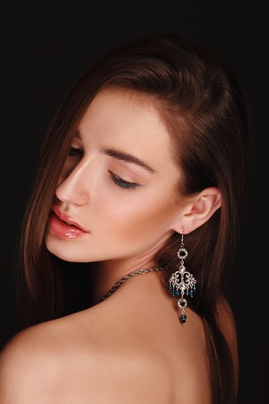 beautiful model lady with natural make-up. studio fashion shot on dark background, perfect skinの写真素材