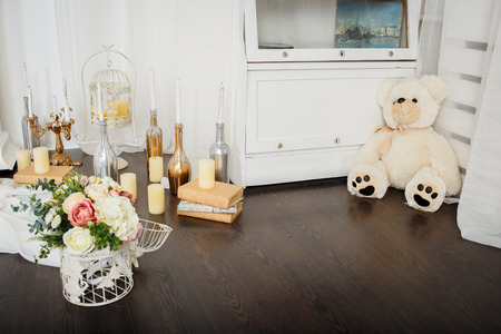 Spring flowers decoration beautiful fireplace with candles and unusual wreath on the wallの写真素材