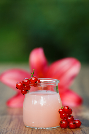 jar of cold pink cocktail on green background bokehの写真素材