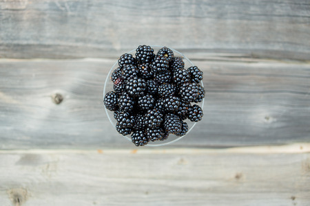 organic blackberries in a glass on a gray wooden board, rustic, detox,selective focusの写真素材