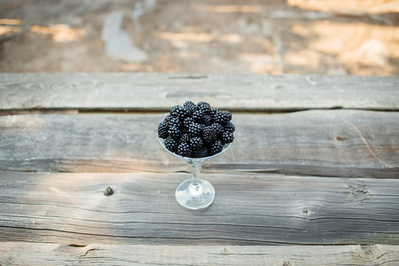 organic blackberries in a glass on a gray wooden board, rustic, detox,selective focusの写真素材