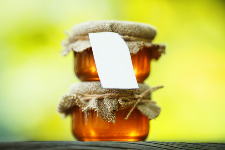 honey in glass jars on wooden table. rural style. eco-styleの写真素材
