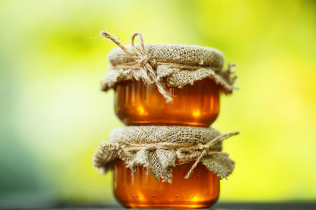 honey in glass jars on wooden table. rural style. eco-styleの写真素材