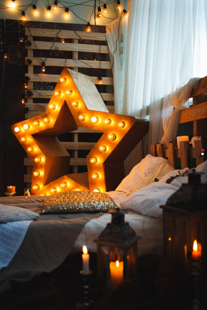 Resting-place with Illuminated star, candles and lampsの写真素材