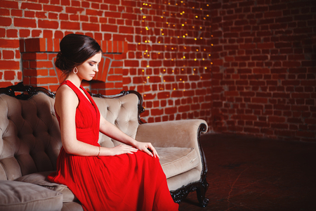 Portrait of Beautiful Sensual smilyng Woman in Fashion Red Dress. Christmas Sales and Shopping concept. Studio shotの写真素材
