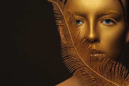 Fantasy. Face of Styled Enigmatic Woman with Gold Make-up. Luxuryの写真素材