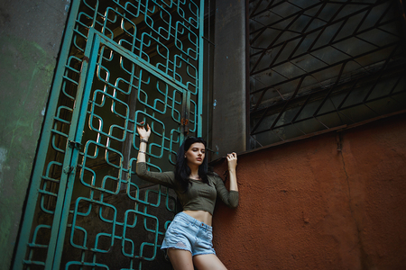 Sexy and pretty brunette in shorts posing on the streets.の写真素材