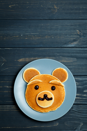 Children Bear Breakfast. Bear-shaped Pancakes - Creative Idea for Kids Easter Breakfast with Space for Textの写真素材