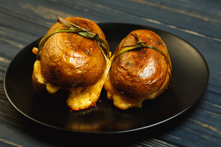 Stuffed potato with bacon, cheese and green garlic, top view. Dinner in country styleの写真素材