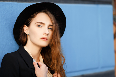 Red-haired girl with a black hat with long hair. Bright unusual appearanceの写真素材