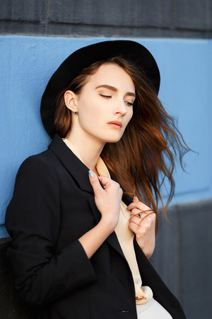 Red-haired girl with a black hat with long hair. Bright unusual appearanceの写真素材