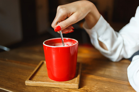 Cup of coffee on wooden table, front viewの写真素材