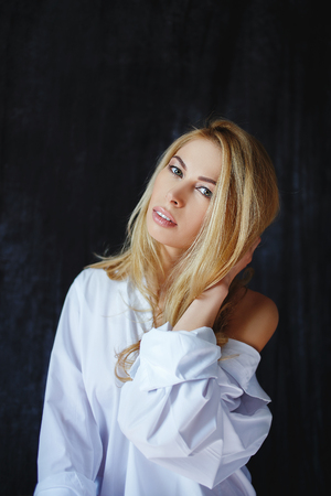 fashion luxury blonde girl in mans shirtの写真素材