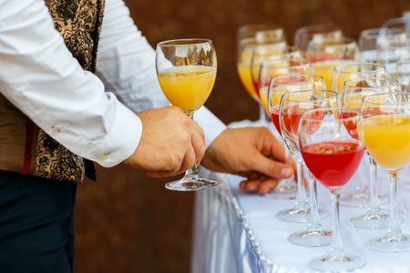 Glasses in a row at a buffet tableの写真素材