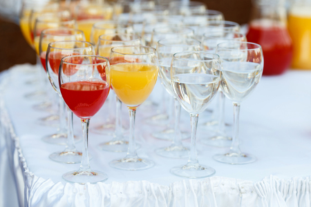 Glasses in a row at a buffet tableの写真素材