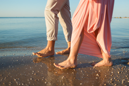 couple walking along the beachの写真素材