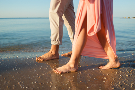 couple walking along the beachの写真素材