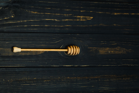 spoon for honey on dark wood backgroundの写真素材