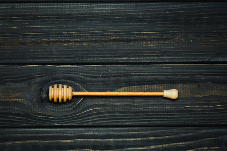 spoon for honey on dark wood backgroundの写真素材