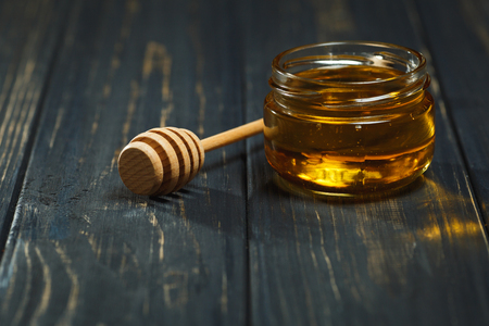 Jar of Honey on Wood Table Still Lifeの写真素材