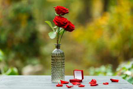 wedding proposal with red roses and a ringの写真素材