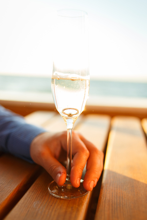 Wedding golden rings in glass of champagne.の写真素材
