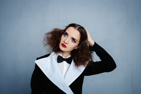 Model in black stylish suit with red lipstickの写真素材