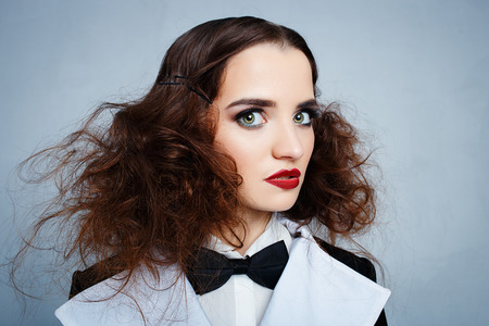 Model in black stylish suit with red lipstick