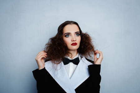 Model in black stylish suit with red lipstickの写真素材