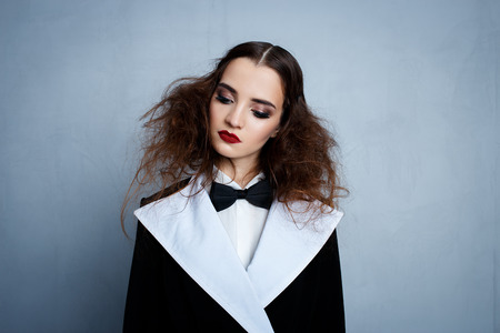 Model in black stylish suit with red lipstickの写真素材