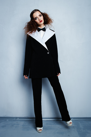 Model in black stylish suit with red lipstickの写真素材