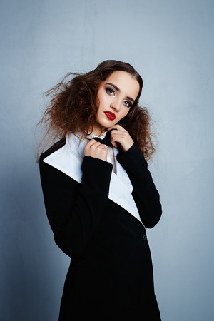 Model in black stylish suit with red lipstickの写真素材