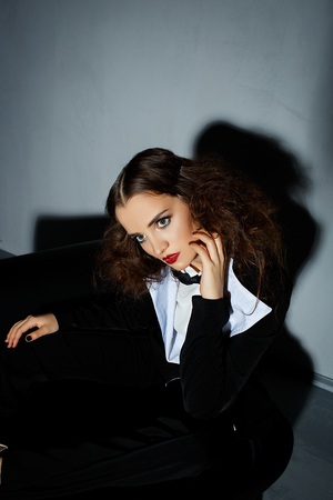 Brunette model posing on couch in the studioの写真素材