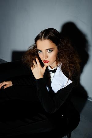 Brunette model posing on couch in the studioの写真素材