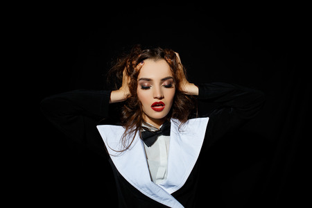 Model in black stylish suit with red lipstickの写真素材