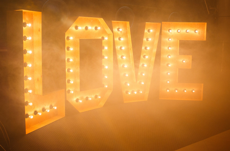 Glowing letters Love made of light bulbsの写真素材