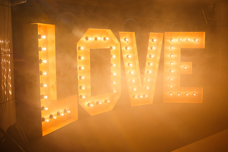 Glowing letters Love made of light bulbsの写真素材