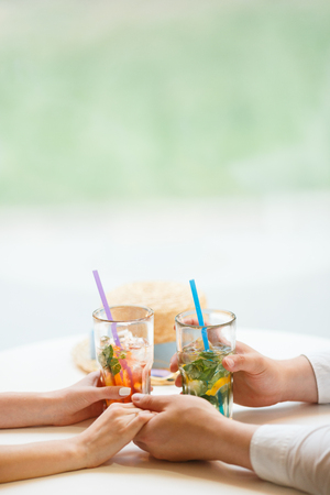 Man giving an engagement ring to his girlfriend In Restaurant. Boyfriend Surprised Her Girlfriend With Engagement Ring in a cafe, drinking cold lemonade with ice.の写真素材